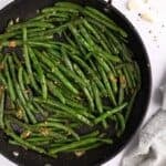 Green beans with garlic in a skillet.