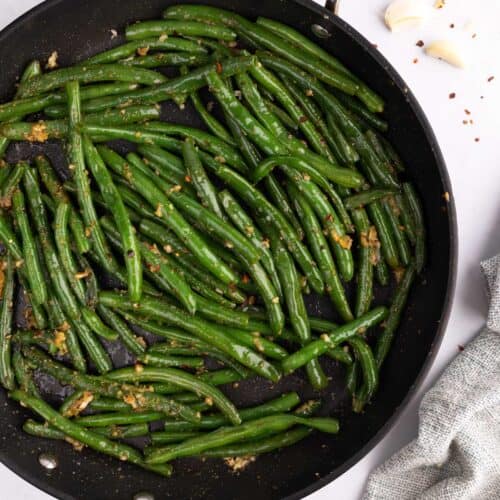 Green beans with garlic in a skillet.